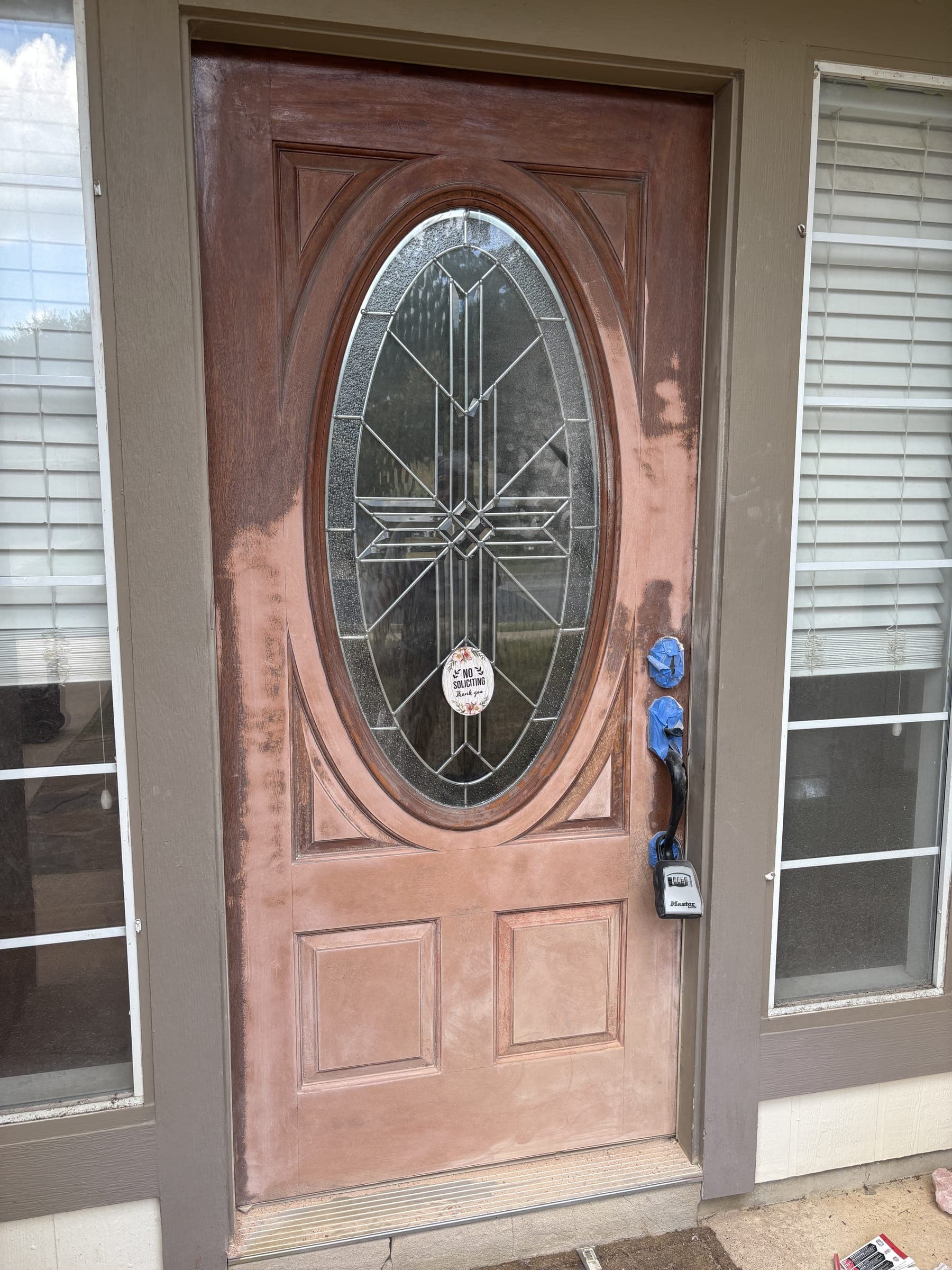 Front door with the finish bleached and flaking after years of sun